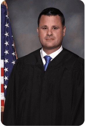 Judge standing by American flag